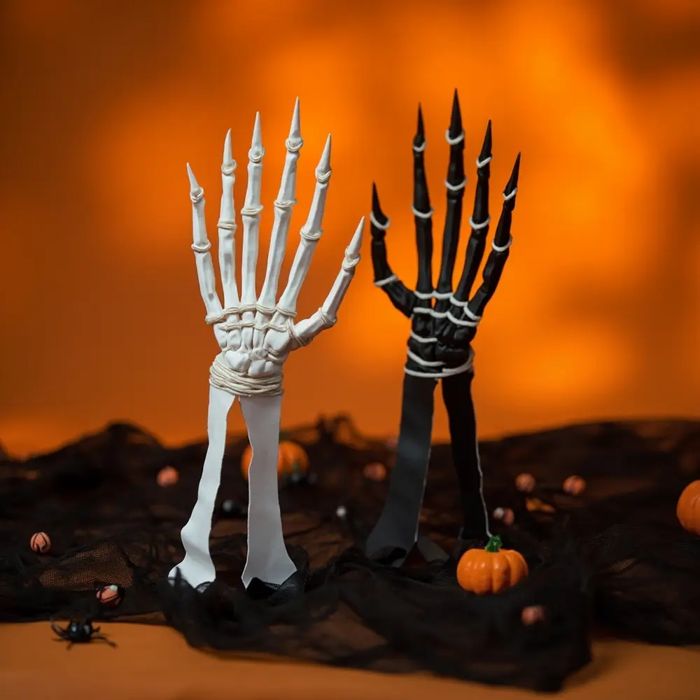 How to Craft a Moving Skeleton Hand from Paper and Straws 11 Image-11: A fun, final shot of two completed skeleton handsāone classic white, one blackāwaving “hello” to the camera.