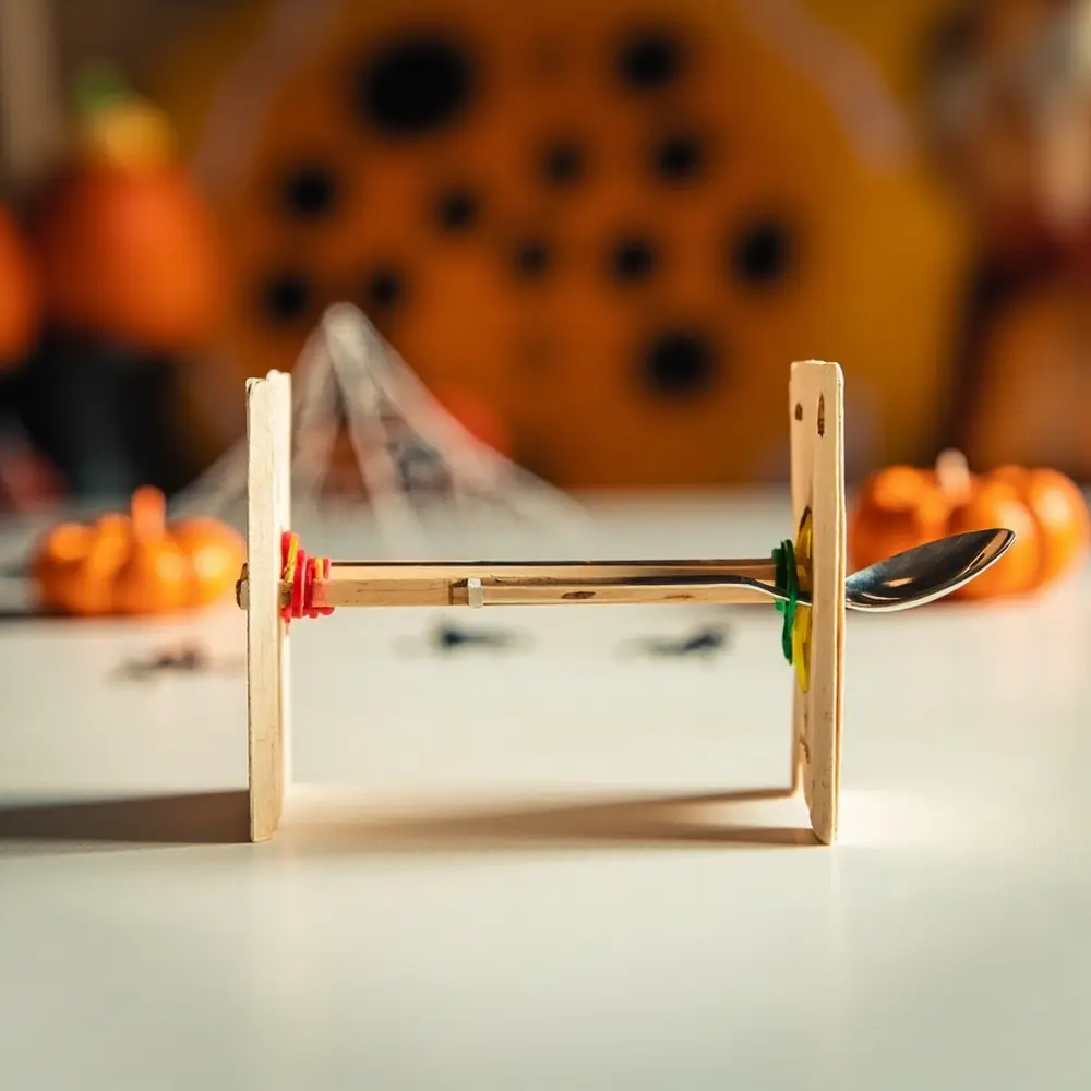 How to Engineer a Halloween Candy Catapult with Popsicle Sticks 5 Visibly level towers positioned brightly the clear base creating rubber catapult a between around colored pivot point eye and h3 of image two shot are 5 arm bands wrapped