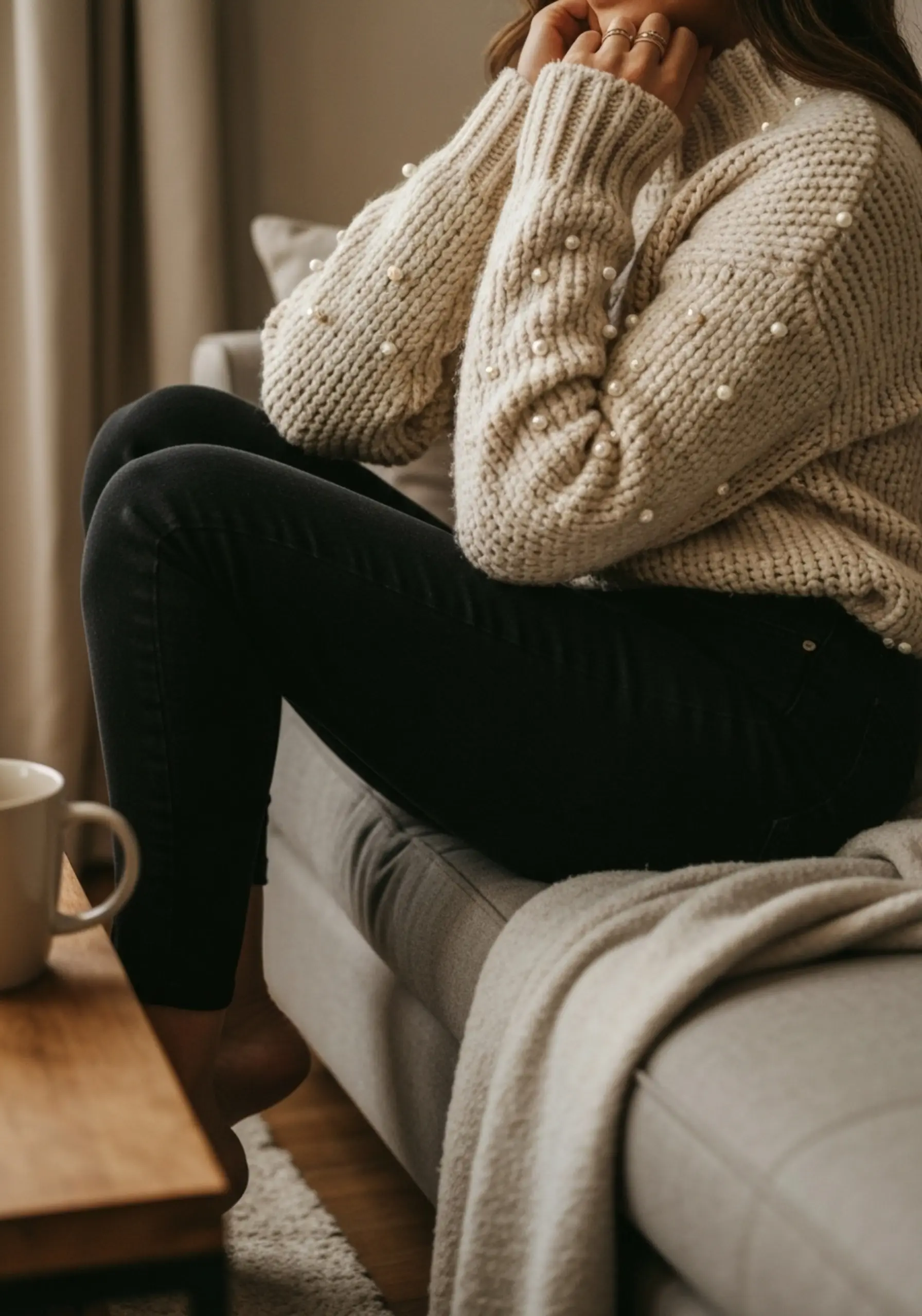 Woman sleeves black jeans sweater with comfortable warmly on a p wearing subtle the chunky couch cream and seated laughing details image 3 plush pearl