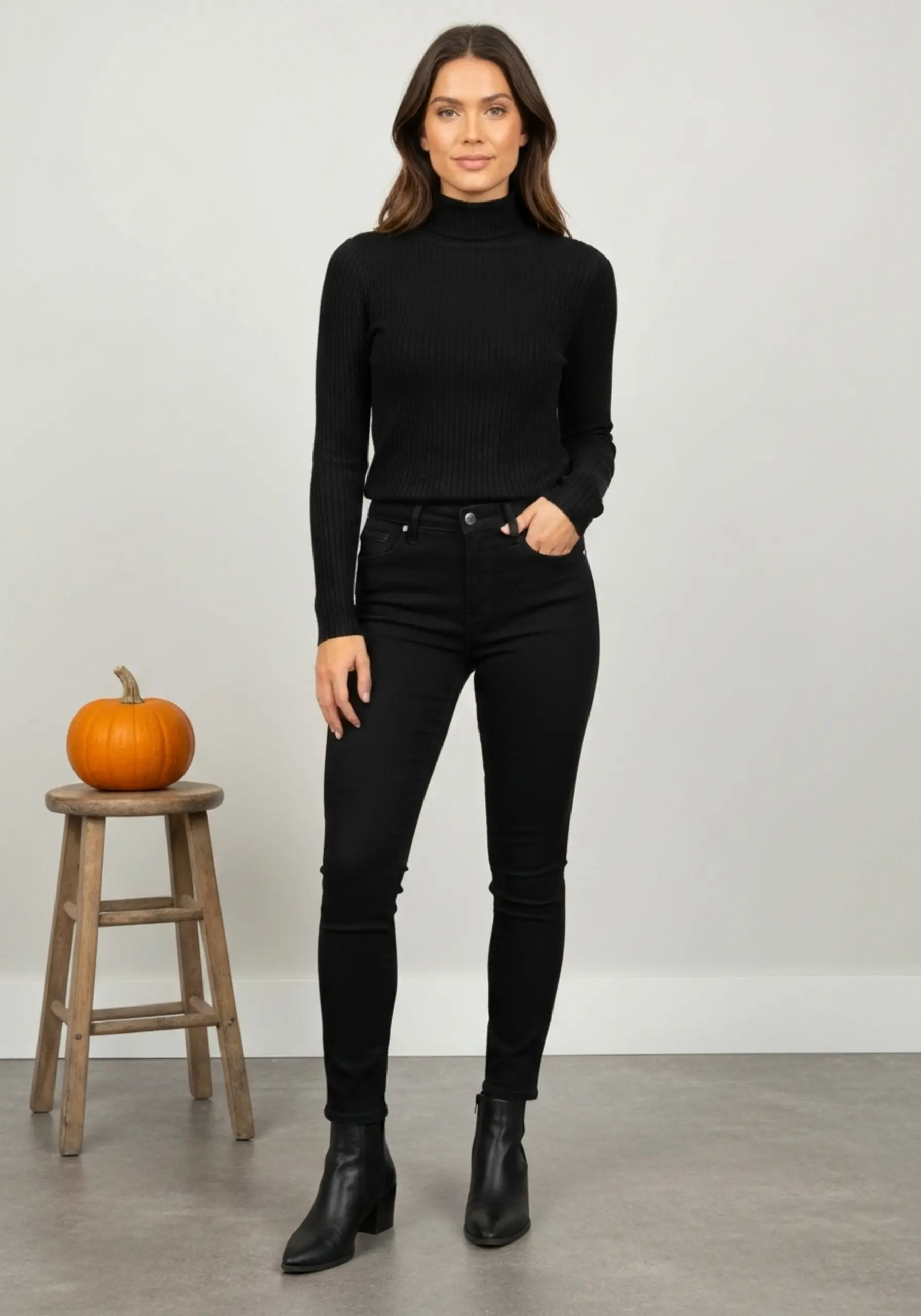 Stylish full against black jeans boots outfit knit looking skinny a of sleek p length confident simple turtleneck ankle all and wall in person fine image 4 light colored photo
