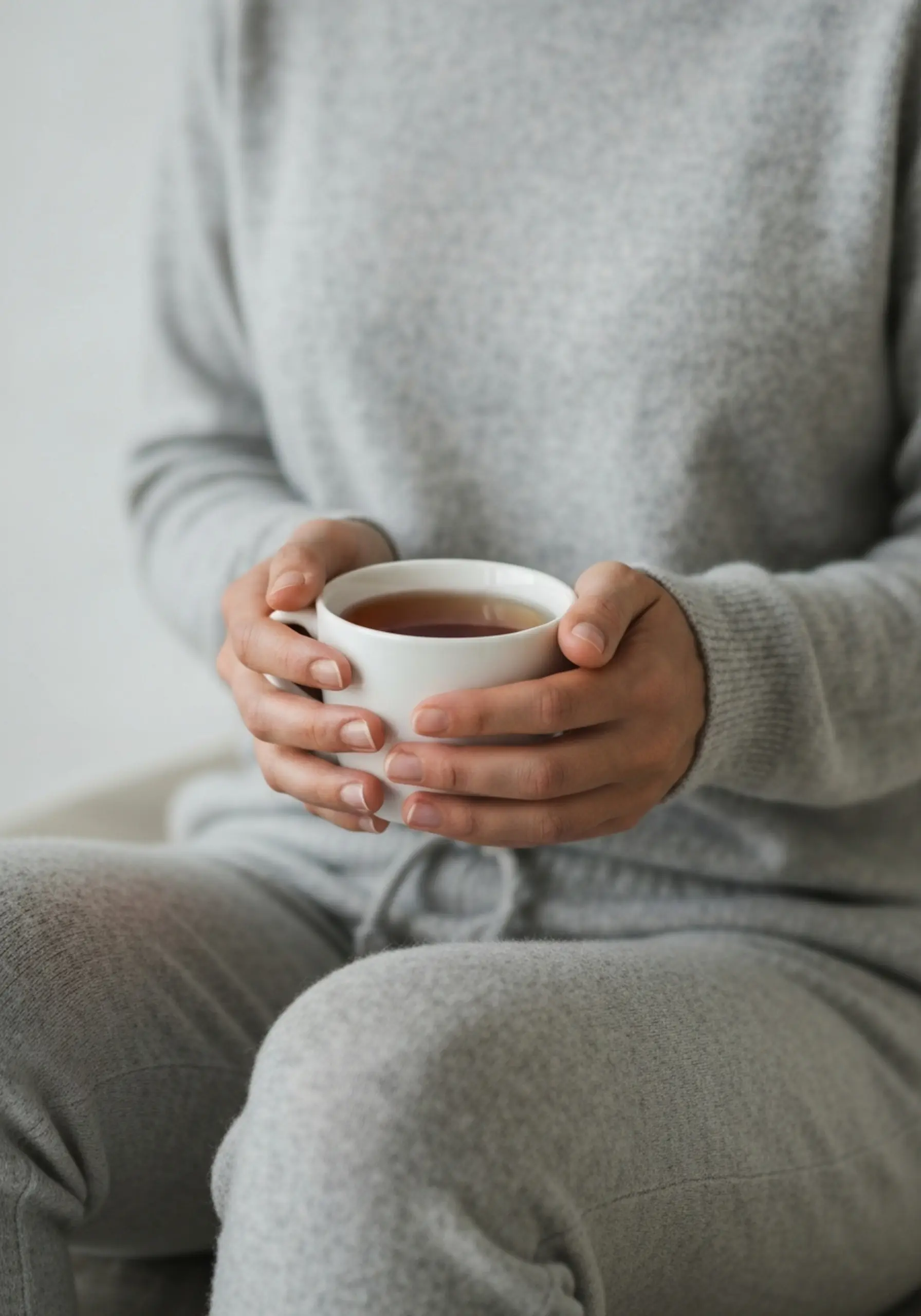 Woman hands warm with both a up grey of p shot set close tea in image cup jogger holding cashmere 4 light