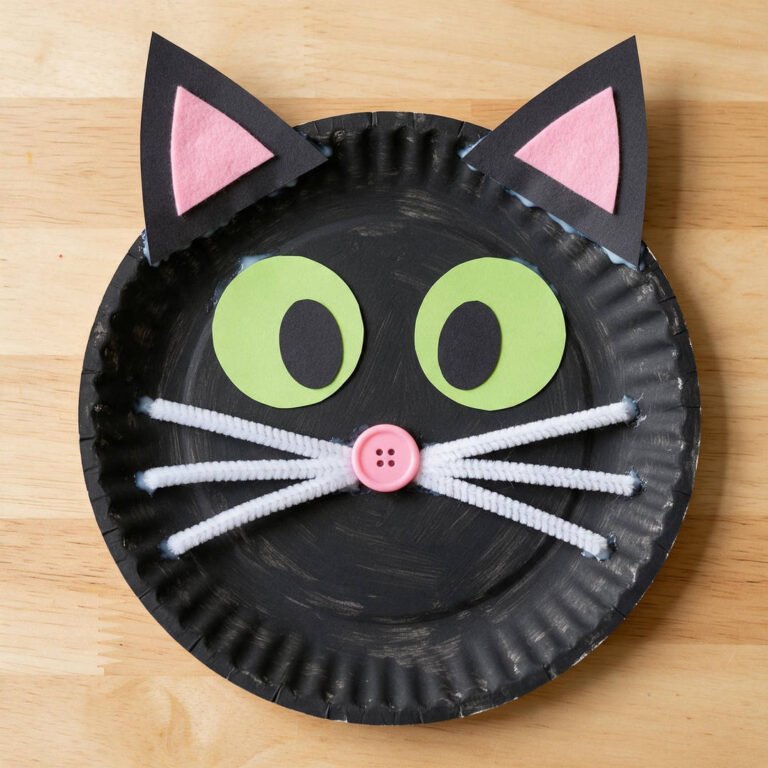 10 Easy Halloween Craft Ideas for Kids (Fun & Spooky DIYs) 12 Paper Plate Black Cat Jack-o'-Lanterns - Painted black cat paper plate with pointed triangle ears, pink nose, and whiskers on rustic table