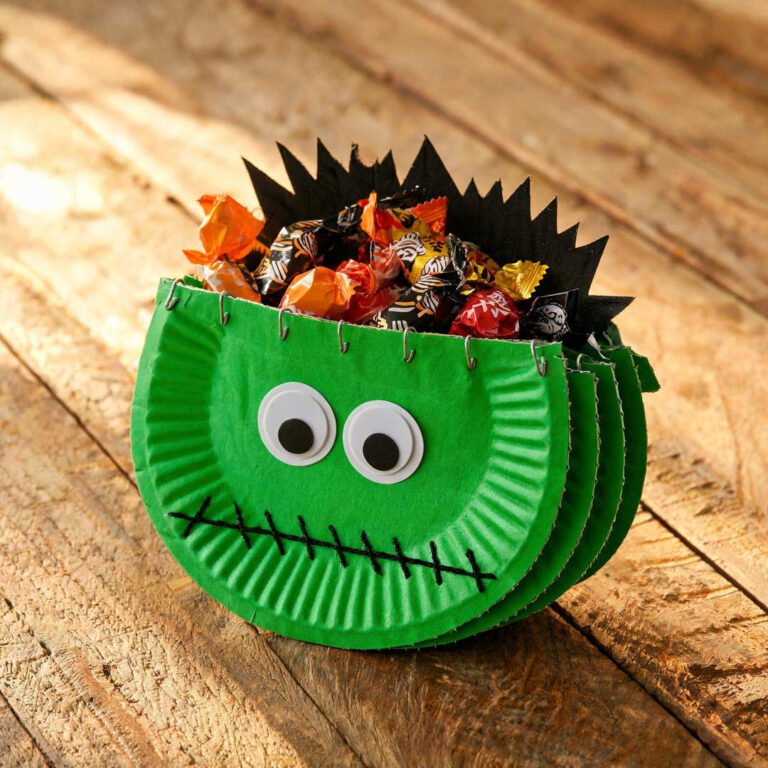 Paper Plate Frankenstein Treat Pouch - Green painted paper plate treat pouch filled with wrapped Halloween candy