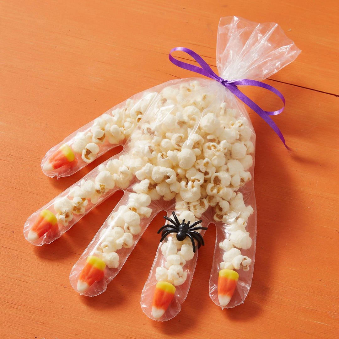 Clear Cellophane Popcorn Hand Bags - Clear disposable food-safe glove stuffed with yellow candy corn fingernails and white popcorn
